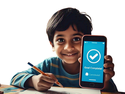 hero page img1 (3) Smiling young boy holding a pencil and showing a smartphone screen with the message “Goal Complete!”.